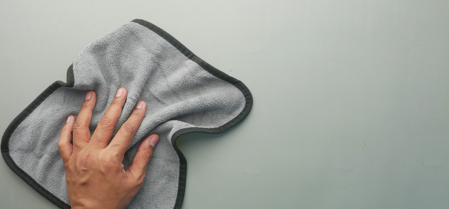 Cleaning a kitchen surface with a microfiber cloth